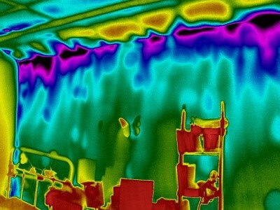 A thermal image of a cold child's room. Internal wall insulation has been installed on the left hand wall but not on the right